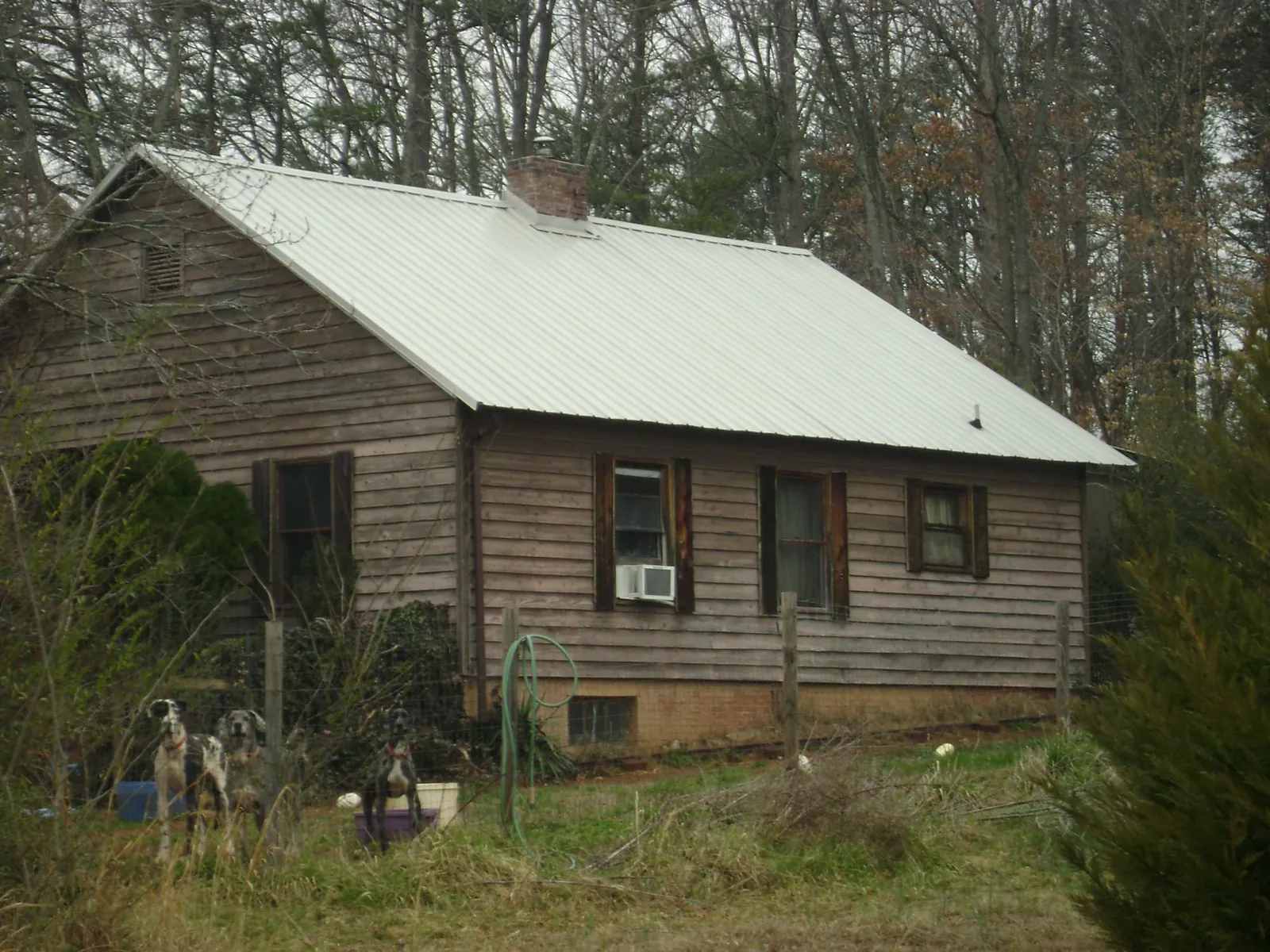 White metal roof on an old wood sided farmhouse, from a Metal Roof Installation job in West Baldwin